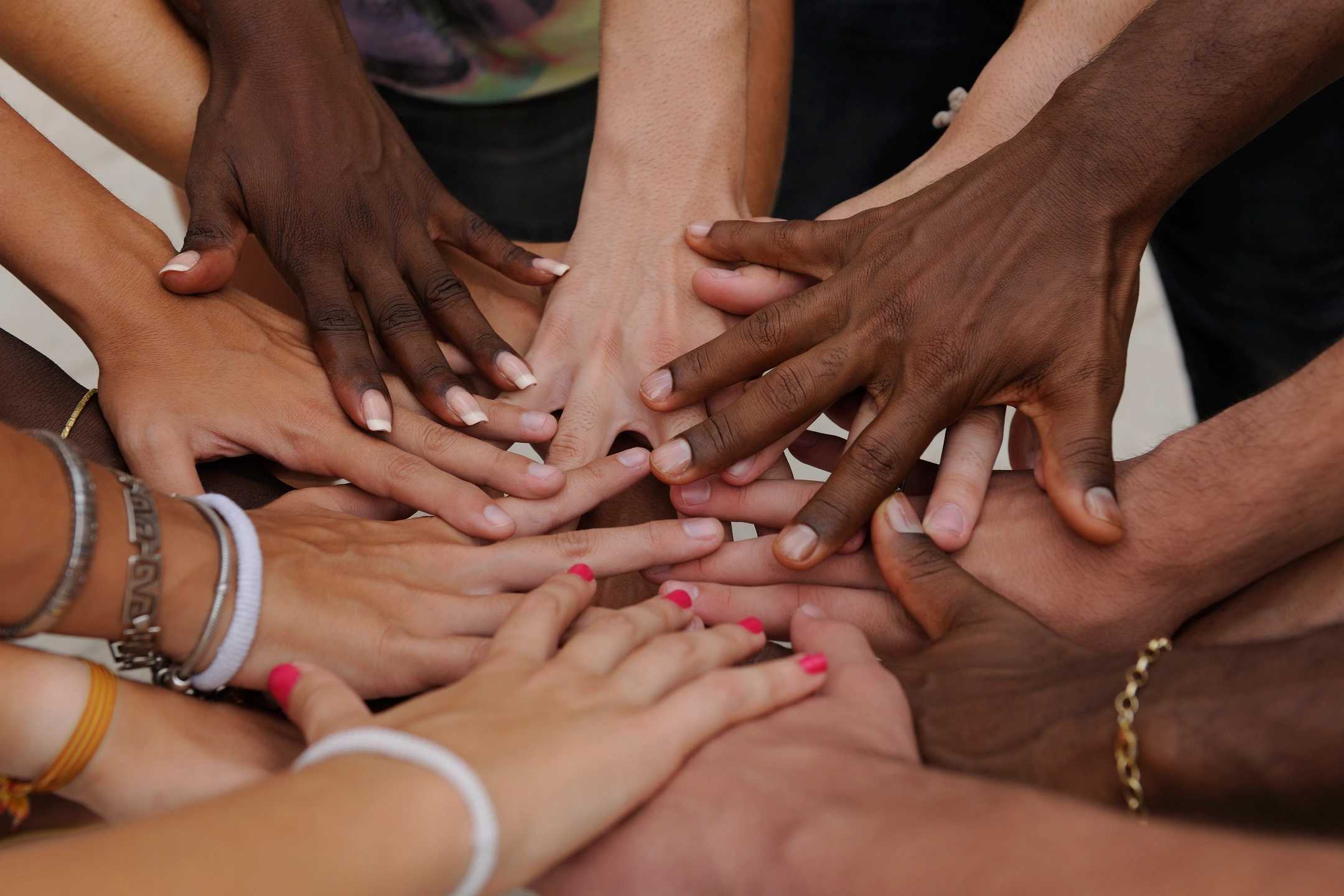 A group of people putting hands together